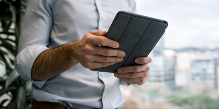 man-looking-at-tablet-in-office